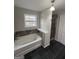 Bathroom featuring a soaking tub with decorative tile surround and a shower at 1232 Memorial Se Dr, Atlanta, GA 30316