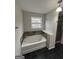 Bright bathroom featuring a soaking tub with decorative tile surround and a shower at 1232 Memorial Se Dr, Atlanta, GA 30316