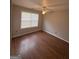 Bedroom with a ceiling fan, laminate floors, and natural light from the window at 1232 Memorial Se Dr, Atlanta, GA 30316