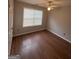 This cozy bedroom features hardwood floors, a ceiling fan, and a window with blinds at 1232 Memorial Se Dr, Atlanta, GA 30316