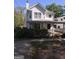 Charming two-story home featuring a covered front porch, light gray siding, and manicured landscaping at 1232 Memorial Se Dr, Atlanta, GA 30316