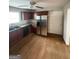 Functional kitchen with stainless steel refrigerator, dark cabinets and hardwood floors at 1232 Memorial Se Dr, Atlanta, GA 30316
