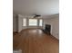 Open living room with hardwood floors, large bay window and a cozy fireplace at 1232 Memorial Se Dr, Atlanta, GA 30316