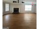 Spacious living area with hardwood floors, a ceiling fan, and a charming fireplace at 1232 Memorial Se Dr, Atlanta, GA 30316