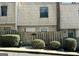 Charming townhouse featuring a wood fence, mature bushes, and a well-maintained shingle facade at 1331 Woodstone Trce, Morrow, GA 30260