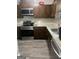 Well-lit kitchen features stainless steel appliances, wood cabinets and granite countertops at 1331 Woodstone Trce, Morrow, GA 30260