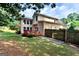 Back exterior with a red deck and a large bay window overlooking the private back yard at 4335 Burgomeister Pl, Snellville, GA 30039