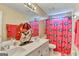 Bathroom featuring double sinks, a large mirror, and a shower curtain adorned with UGA graphics at 4335 Burgomeister Pl, Snellville, GA 30039