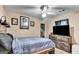 Cozy bedroom with ceiling fan, dresser, TV, and a comfortable bed offering a relaxing retreat at 4335 Burgomeister Pl, Snellville, GA 30039