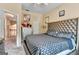 Bedroom with patterned bedding, decorative headboard, and natural light, creating a stylish and comfortable space at 4335 Burgomeister Pl, Snellville, GA 30039