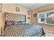 Bedroom with patterned bedding, decorative headboard, and natural light, creating a stylish and comfortable space at 4335 Burgomeister Pl, Snellville, GA 30039
