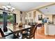 Dining room with a modern chandelier and open view to the kitchen and living room at 4335 Burgomeister Pl, Snellville, GA 30039