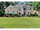 Stunning two-story home with lush landscaping and a stone accented entryway in a desirable neighborhood at 4335 Burgomeister Pl, Snellville, GA 30039