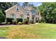 Beautiful front exterior with stone accents, manicured bushes, and a lush lawn at 4335 Burgomeister Pl, Snellville, GA 30039
