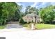 Traditional front exterior with stucco, stone accents, tasteful landscaping, and a sprawling lawn at 4335 Burgomeister Pl, Snellville, GA 30039