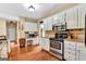 Bright kitchen with stainless steel appliances, white cabinets and a wooden floor at 4335 Burgomeister Pl, Snellville, GA 30039
