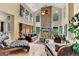 Spacious living room with vaulted ceilings, stone fireplace, and abundant natural light creating an open, inviting space at 4335 Burgomeister Pl, Snellville, GA 30039