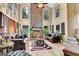 Inviting living room featuring high ceilings, stone fireplace, and a cozy atmosphere for gatherings at 4335 Burgomeister Pl, Snellville, GA 30039
