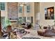 Elegant living room featuring a stone fireplace, tall windows, and comfortable seating at 4335 Burgomeister Pl, Snellville, GA 30039