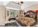 A Primary bedroom boasting a large bed, window seat and a ceiling fan at 4335 Burgomeister Pl, Snellville, GA 30039