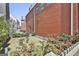 A quaint backyard with lush greenery and a classic red brick home exterior adds charm at 175 Central Ave, Fayetteville, GA 30214