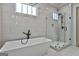 Bright bathroom featuring a freestanding tub, glass-enclosed shower, and stylish black matte fixtures at 175 Central Ave, Fayetteville, GA 30214