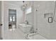Bright and airy bathroom featuring a freestanding tub and glass-enclosed shower with tiled walls at 175 Central Ave, Fayetteville, GA 30214