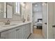 Bright bathroom with double vanity, quartz countertops, and entry to the bedroom at 175 Central Ave, Fayetteville, GA 30214