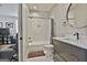 Charming bathroom featuring subway tile, a round mirror, and modern fixtures, exuding elegance at 175 Central Ave, Fayetteville, GA 30214