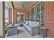 Relaxing covered porch with a cozy seating area, ideal for enjoying the outdoors in comfort at 175 Central Ave, Fayetteville, GA 30214