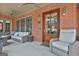 Charming covered porch featuring stylish seating and an inviting outdoor living space at 175 Central Ave, Fayetteville, GA 30214