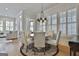 Dining area with round wooden table, seating for six, plantation shutters, hardwood floors at 175 Central Ave, Fayetteville, GA 30214