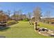 Vibrant dog park with playful green hills, modern doggie amenities, and a secure fence at 175 Central Ave, Fayetteville, GA 30214