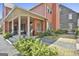 Charming brick house featuring a covered porch with ceiling fans and landscaped yard at 175 Central Ave, Fayetteville, GA 30214