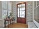 Beautiful foyer entrance boasting warm hardwood floors and elegant décor with glass paneled door at 175 Central Ave, Fayetteville, GA 30214
