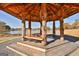 Rustic wooden gazebo with seating, offering a serene lakeside view in a natural setting at 175 Central Ave, Fayetteville, GA 30214