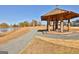 Picturesque gazebo by a tranquil lake, surrounded by scenic autumn trees and walking path at 175 Central Ave, Fayetteville, GA 30214