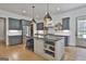 Spacious kitchen featuring an island, stainless steel appliances, ample cabinet space and modern lighting at 175 Central Ave, Fayetteville, GA 30214