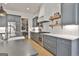 Updated kitchen featuring gray cabinets, stainless steel appliances, subway tile backsplash, and wooden shelves at 175 Central Ave, Fayetteville, GA 30214