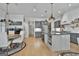 Well-lit open-concept kitchen featuring grey cabinets, a large island, stainless steel appliances, and dining area at 175 Central Ave, Fayetteville, GA 30214