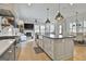Modern kitchen with stainless steel appliances, farmhouse sink, island with bar stools and open to the living area at 175 Central Ave, Fayetteville, GA 30214