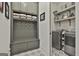 Well-organized laundry room with washer, dryer, storage cabinets, hanging space, and patterned tile flooring at 175 Central Ave, Fayetteville, GA 30214