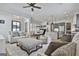Open-concept living room with hardwood floors, neutral furniture, and a view of the kitchen and dining area at 175 Central Ave, Fayetteville, GA 30214