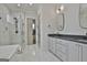 Bright main bathroom with double vanity, soaking tub, walk-in shower, and sleek tile flooring for a spa-like experience at 175 Central Ave, Fayetteville, GA 30214