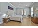 Comfortable main bedroom with large windows, hardwood floors, and a cozy ambiance perfect for relaxation at 175 Central Ave, Fayetteville, GA 30214