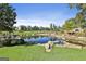 Picturesque community pond surrounded by lush landscaping, with seating areas and luxury homes nearby at 175 Central Ave, Fayetteville, GA 30214
