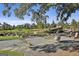 Breathtaking view of community pond, lush greenery, and comfortable seating with nearby luxury homes at 175 Central Ave, Fayetteville, GA 30214