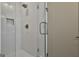 Modern shower featuring white tile, sleek glass door, and chrome fixtures at 175 Central Ave, Fayetteville, GA 30214