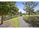 Scenic community walking path featuring lush greenery, manicured lawns, and beautiful landscaping at 175 Central Ave, Fayetteville, GA 30214