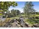 Picturesque water feature with rock lined creek, lush landscaping and mature trees creating a serene environment at 175 Central Ave, Fayetteville, GA 30214